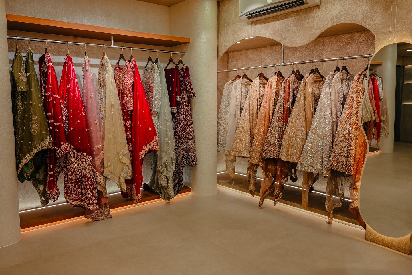 Rail of cream and gold reception gowns at Allura