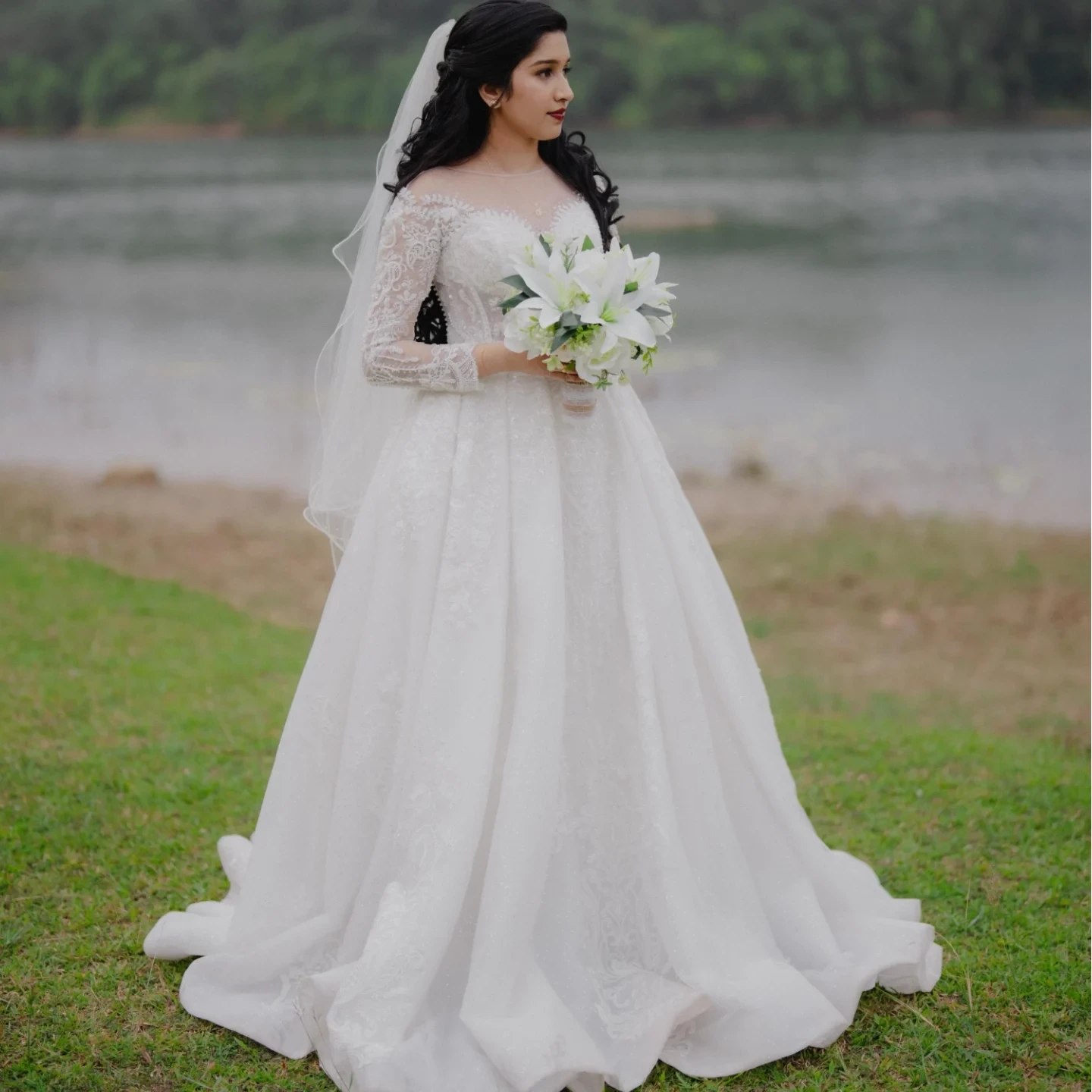 Anaya in a Christian wedding gown by a lakeside