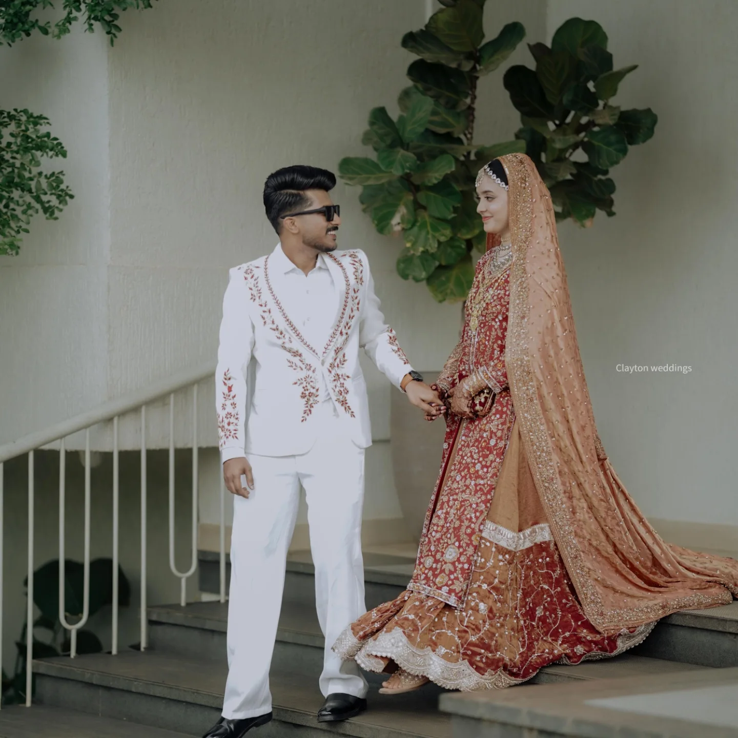 Anjana and Vishnu on the steps of a colonial home